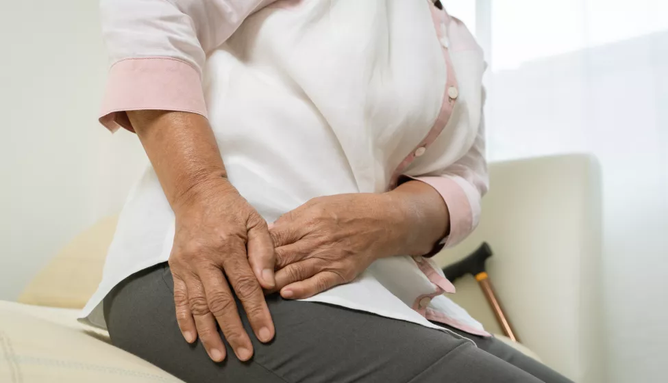 Hip pain of senior woman at home, healthcare problem of senior concept