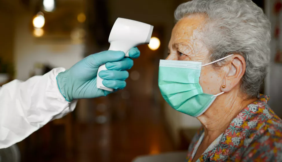 Woman Having Temperature Taken