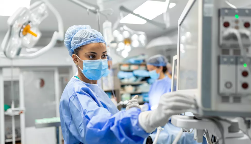 Doctor working in an operating room checking monitors