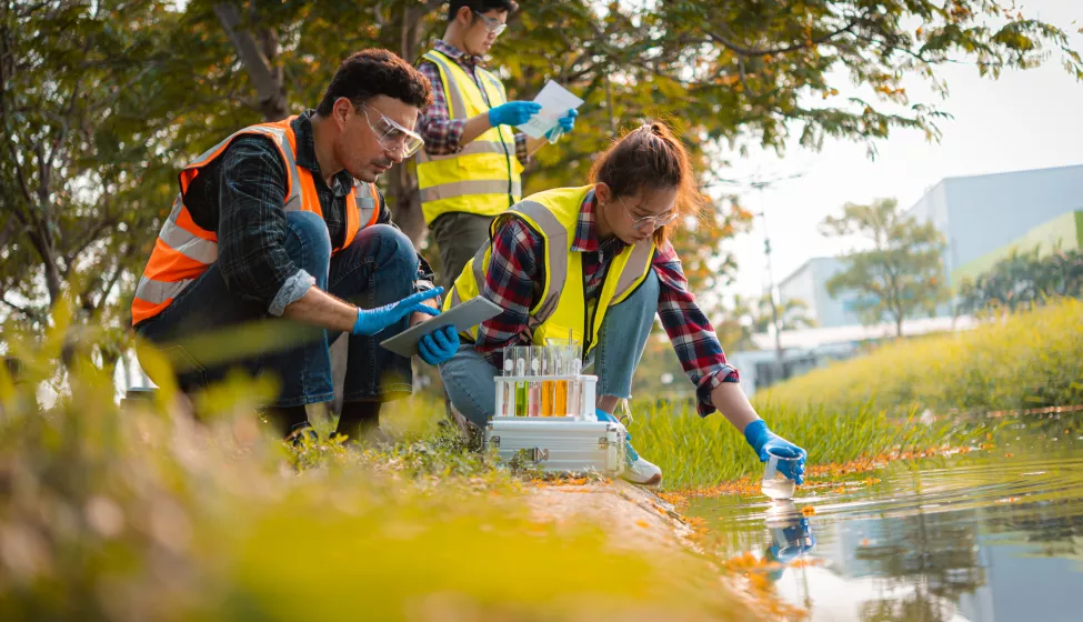 Scientists team collect water samples for analysis and research