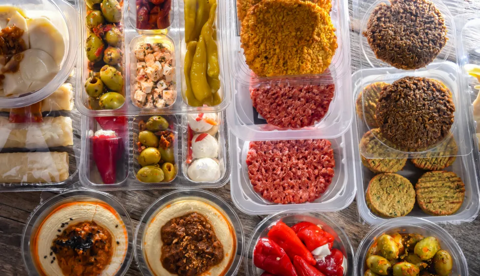 Variety of prepackaged food products in plastic boxes