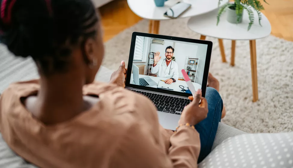 Young Pregnant Woman Having A Doctor's Appointment On A Laptop