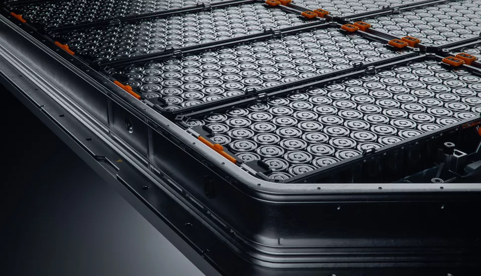 Close-up of EV Battery Pack with Orange Connectors Isolated on Black Background