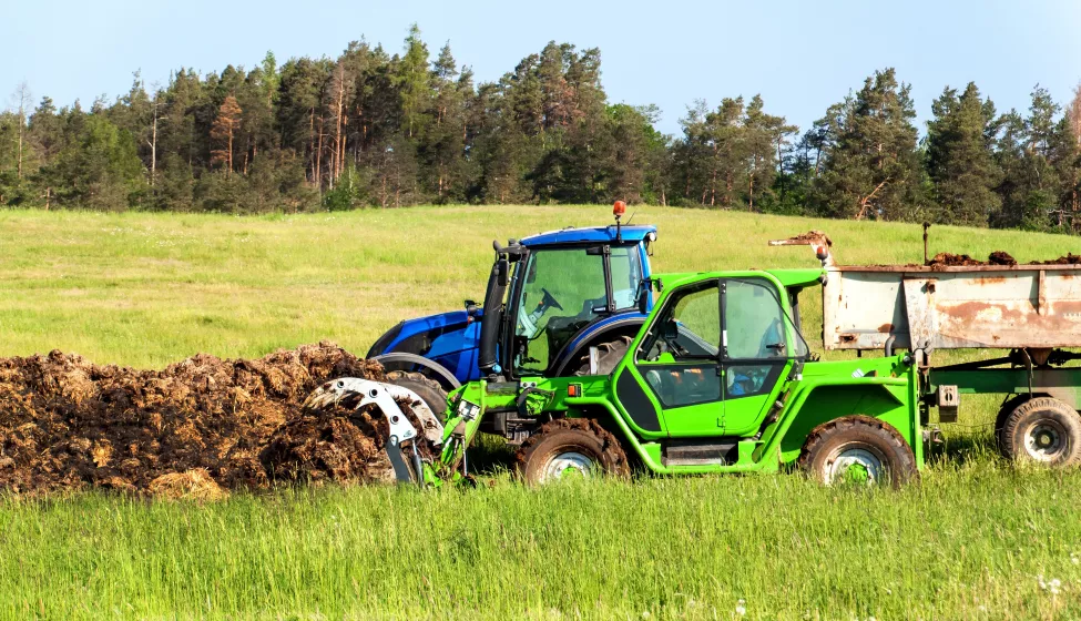 Loading Manure onto a tractor in a field