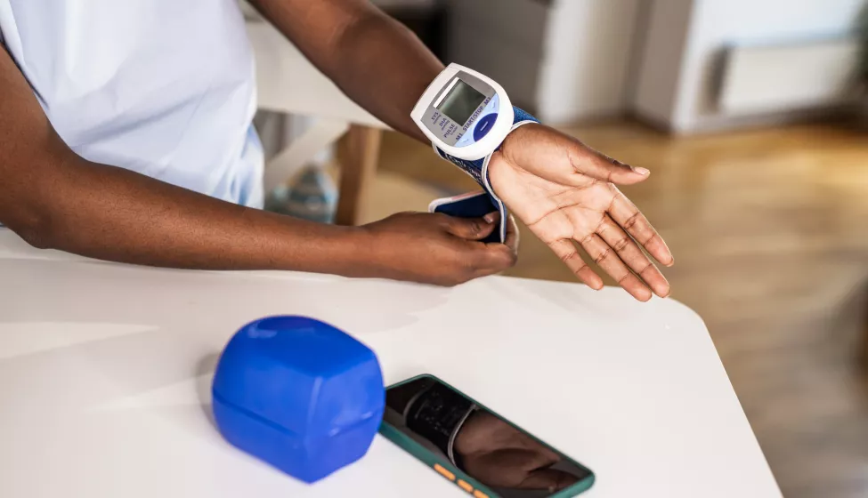 Young woman measuring a blood pressure at home