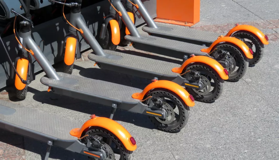 A line of e-scooters parked outside