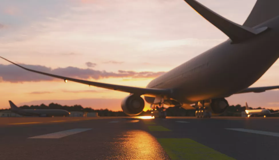 View from behind a plane on runway a sunset