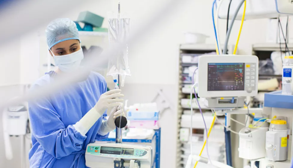 Nurse Standing By Medical And Monitoring Equipment