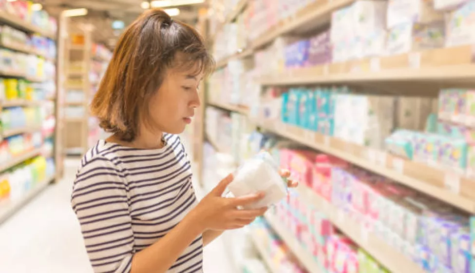 Asian Woman Shopping Sanitary Napkin At The Supermarket