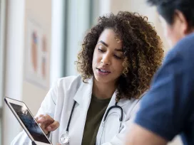 Medical worker registesr patients on tablet device. Exponent studies real - world outcomes for new medical devices and pharmaceuticals.