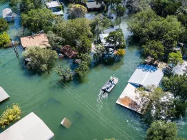 Flat bottom boat navigates through flooded neighborhoods. Exponent engineers respond to storms and natural disasters.