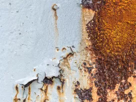 Exposed rust and flaking material on an exterior surface. Exponent materials and corrosion engineering support.