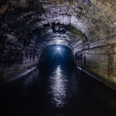 Dark flooded concrete tunnel