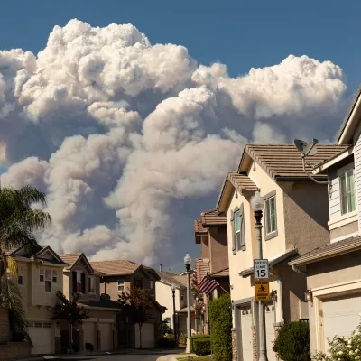 Smoke from a fire behind a neighborhood