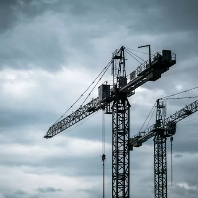 Construction tower cranes on a building site